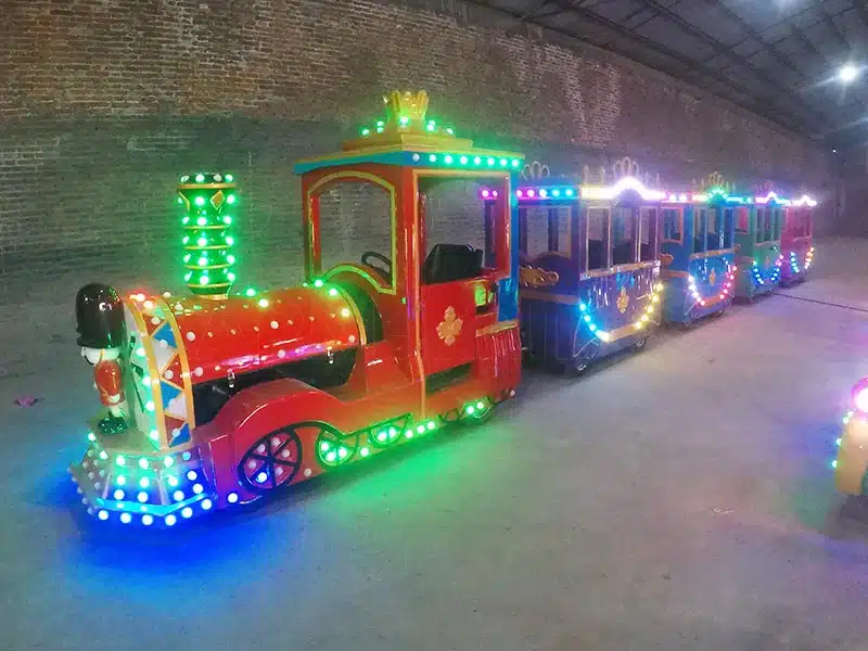 Electric Trackless train with red and green carriages