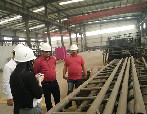 Customers visiting Carnee Rides production workshop to inspect amusement equipment manufacturing