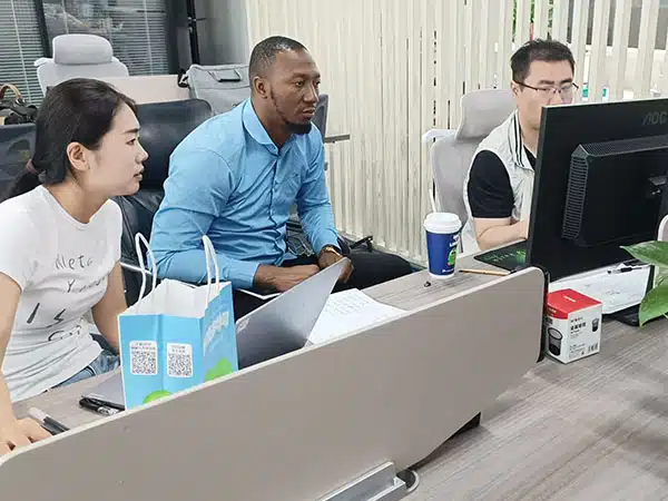 Customer discussing amusement ride design drawings with Carnee Rides team in the office