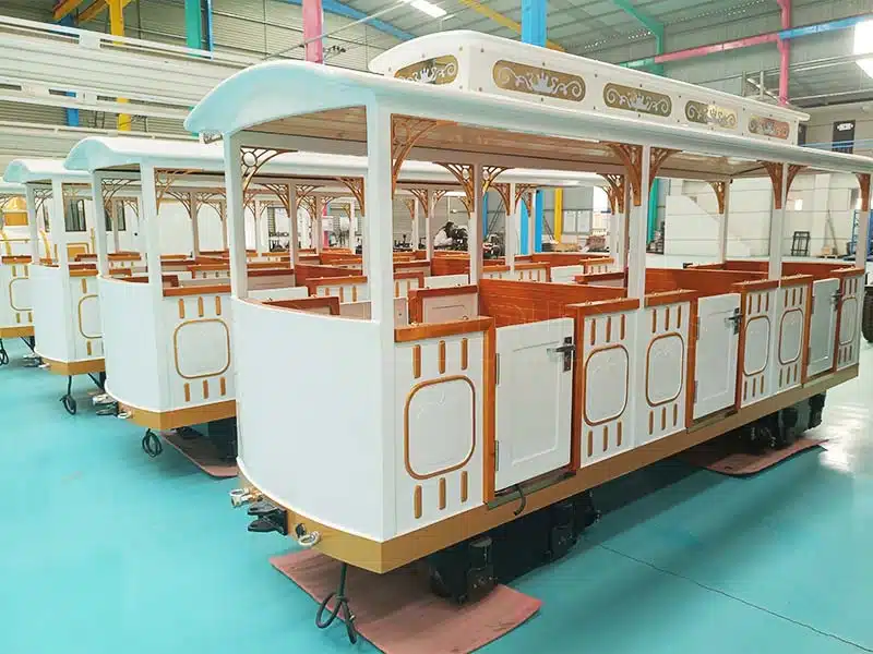 Painted and finished carriages of the trackless train in the production workshop.