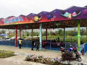 Classic fairground bumper cars pavilion with colorful graphics for outdoor dodgems arena