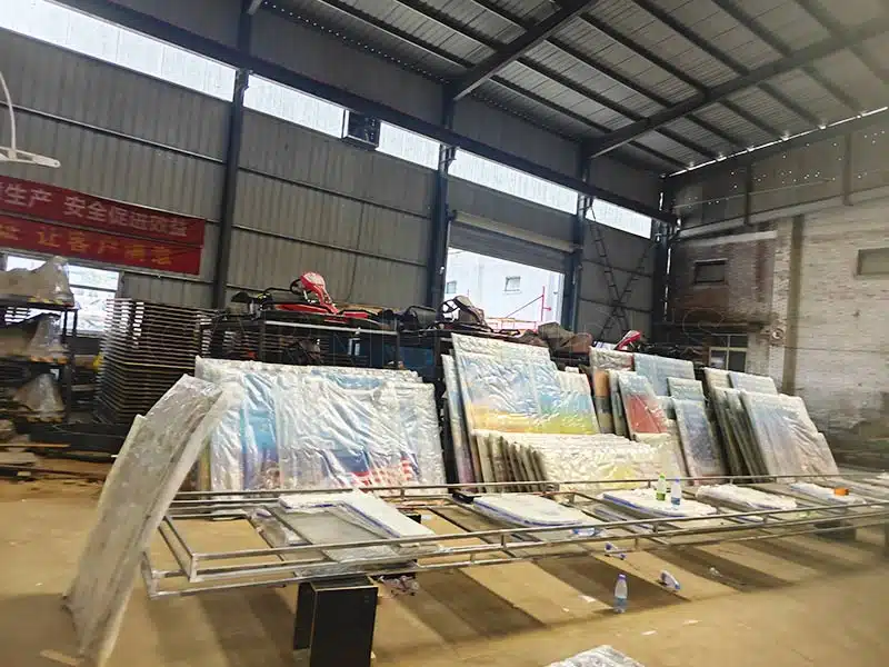 Factory workshop showing bumper car floor grid panels and manufacturing materials used for ground grid dodgem rides.