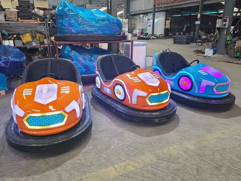 Electric bumper cars displayed at a trade exhibition, showing upgraded lighting and design for amusement park customers.