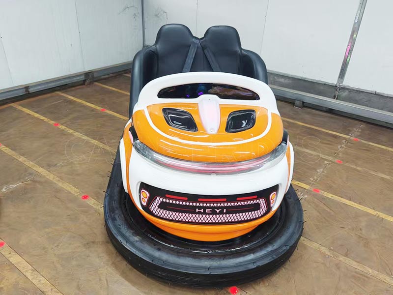 Large two-seat battery bumper car in orange and white, designed for commercial amusement parks and rental events.