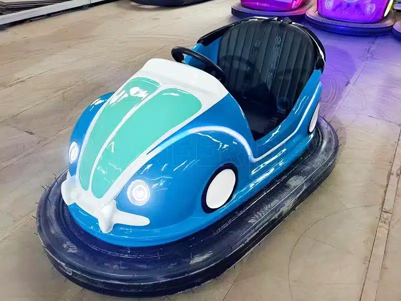 Retro blue beetle-style ceiling bumper car with vintage appearance, overhead conductive pole and sturdy rubber bumper ring.