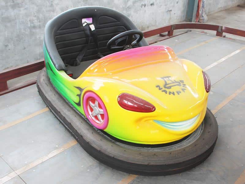 Rainbow smiley-style ceiling bumper car with cartoon design, perfect for children’s indoor amusement parks using overhead grid power.