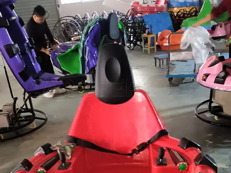 Inside the manufacturing workshop of a leading inflatable bumper car supplier, showing black base bases, blue steel frames, and raw components ready for full assembly.