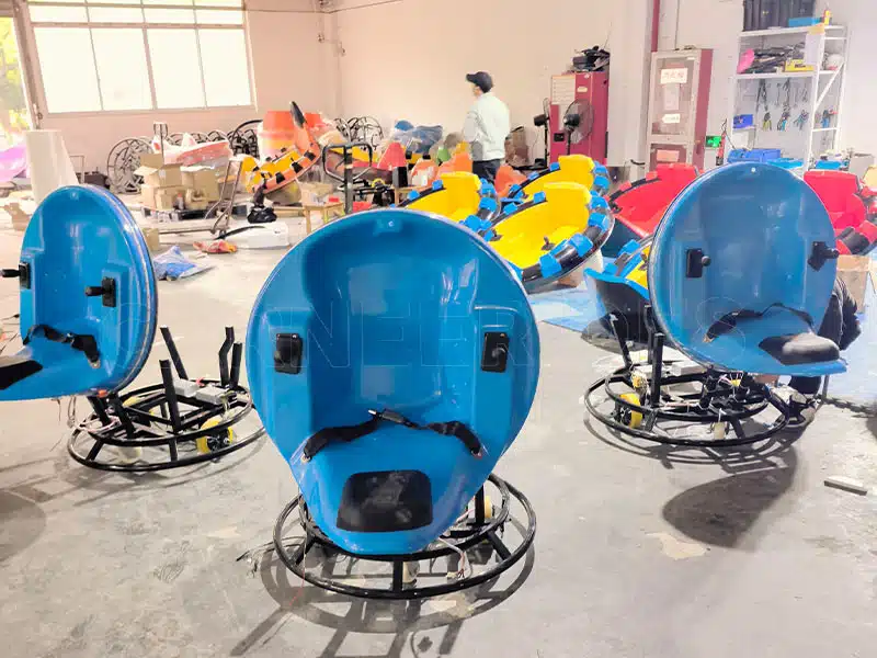 Multiple raw, high-strength steel frame chassis for commercial-grade inflatable bumper cars lined up in the factory for welding and coating inspection.