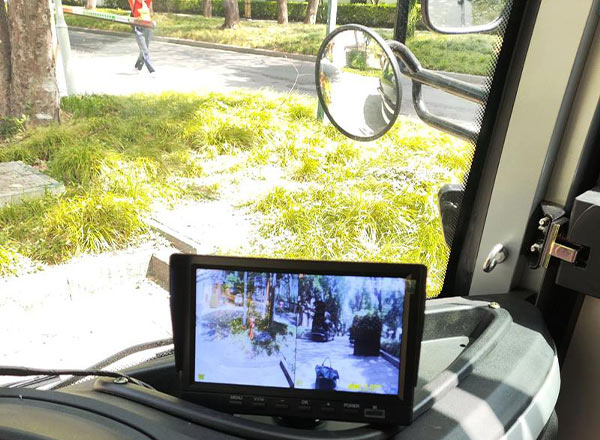 Trackless train dashboard featuring a rearview safety camera monitor for safe driving and operation.