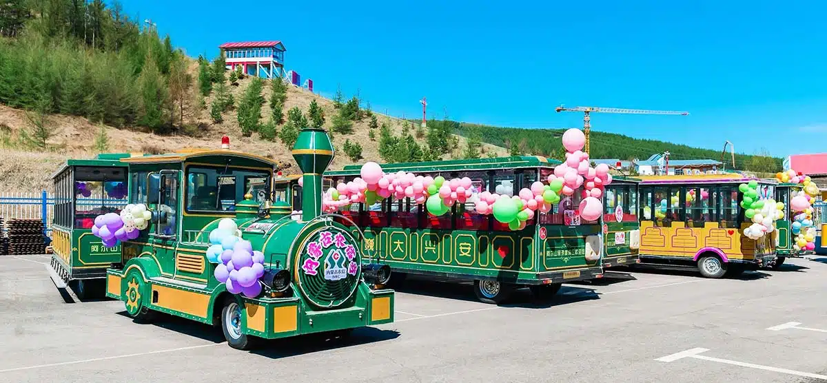 Sightseeing trackless tourist train decorated with balloons for resort scenic area and family park operation