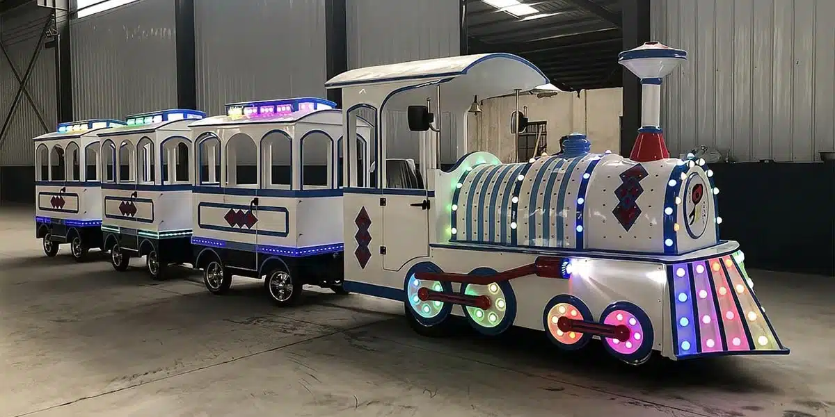 Electric trackless train with LED lighting and multiple enclosed passenger carriages prepared in the factory