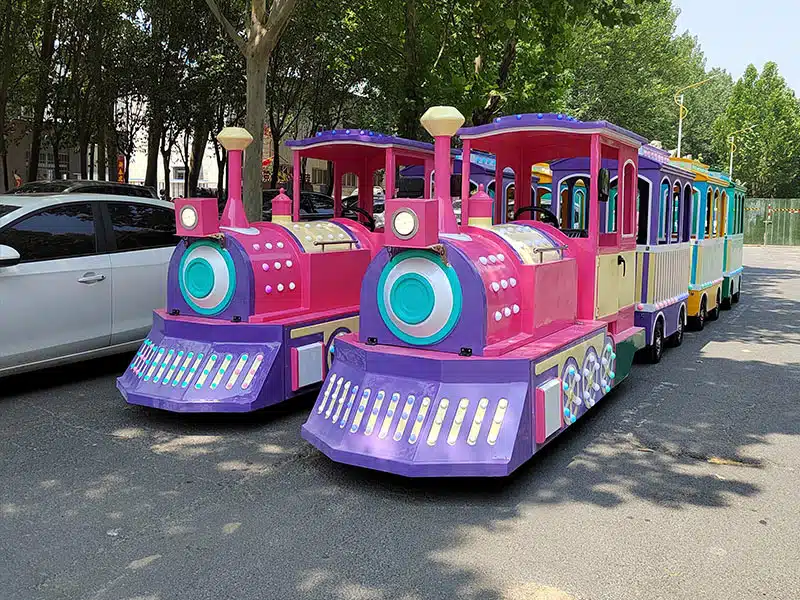 Two compact pink kiddie trackless trains for shopping malls, parks and children's amusement attractions
