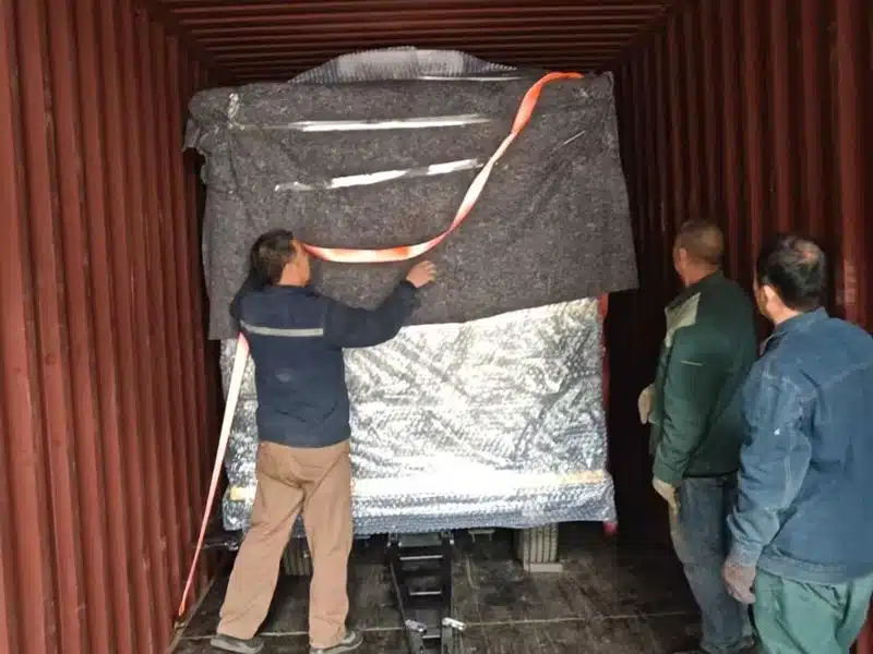 Trackless train packed and secured inside a shipping container for overseas delivery